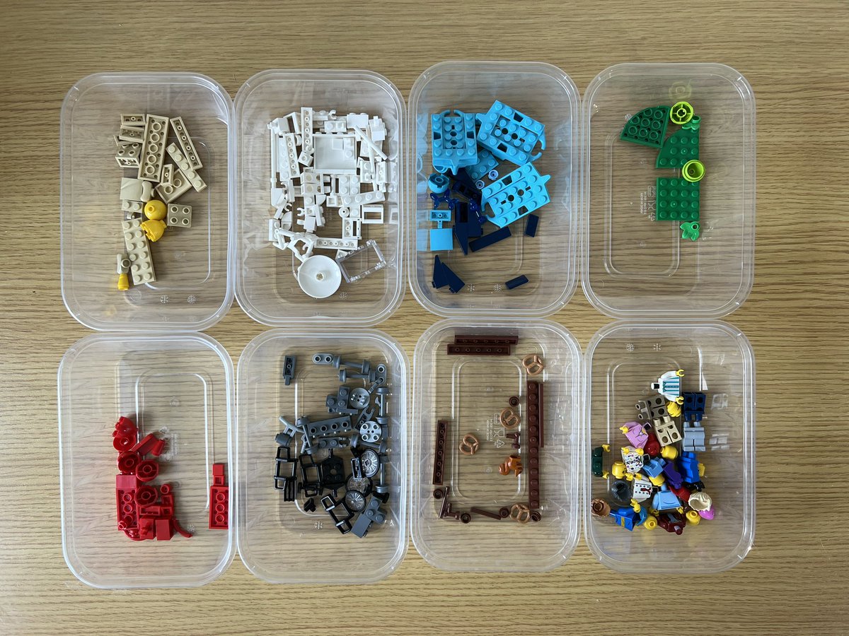 8 pots of lego sorted by colour. There are reds, blues, greens, browns, blacks, whites, tan, and a pot of minifigure parts