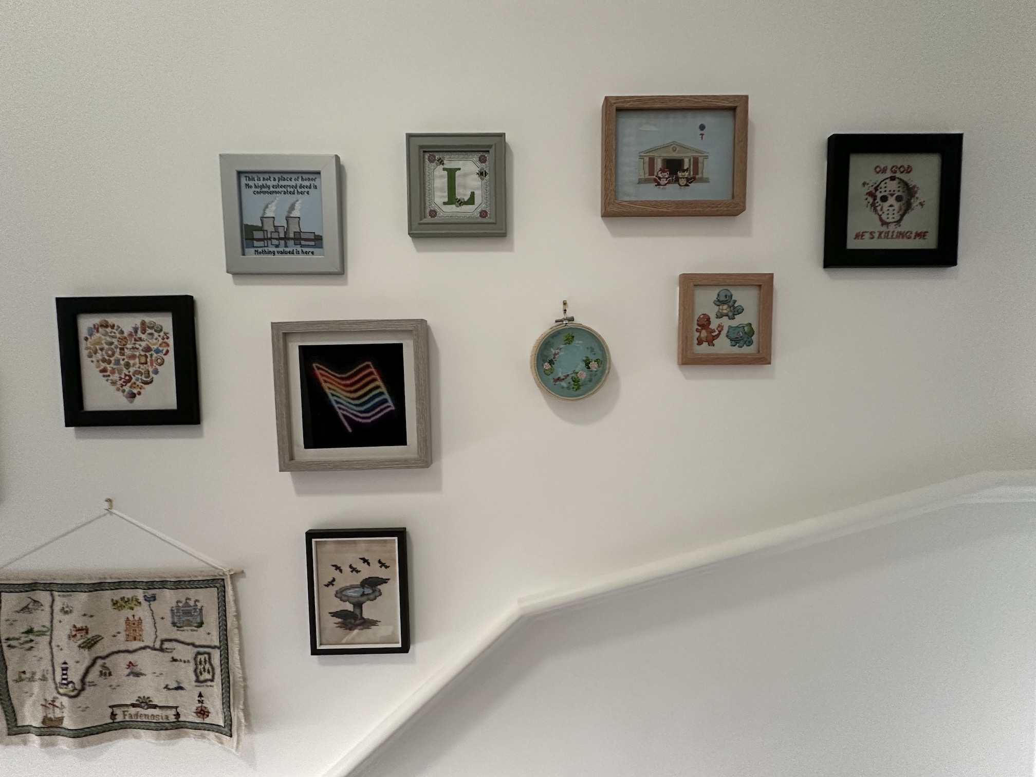 Another ten cross stitches hung further up the same wall.